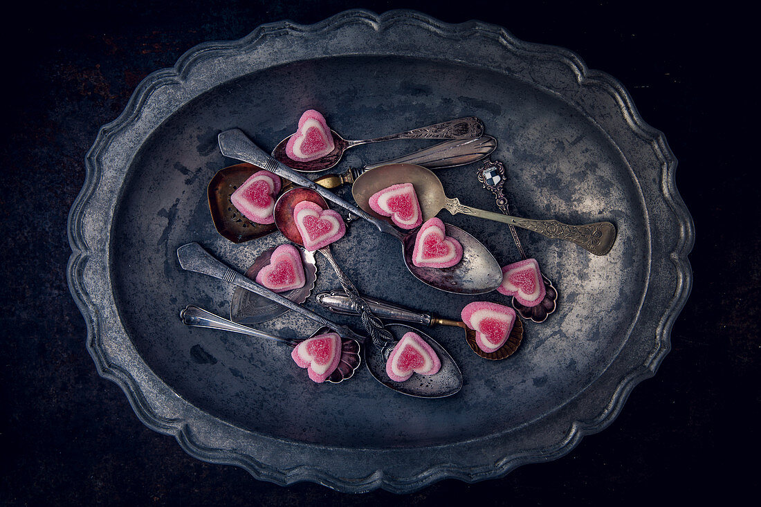 Vintage spoons with vanilla hearts in a metal bowl
