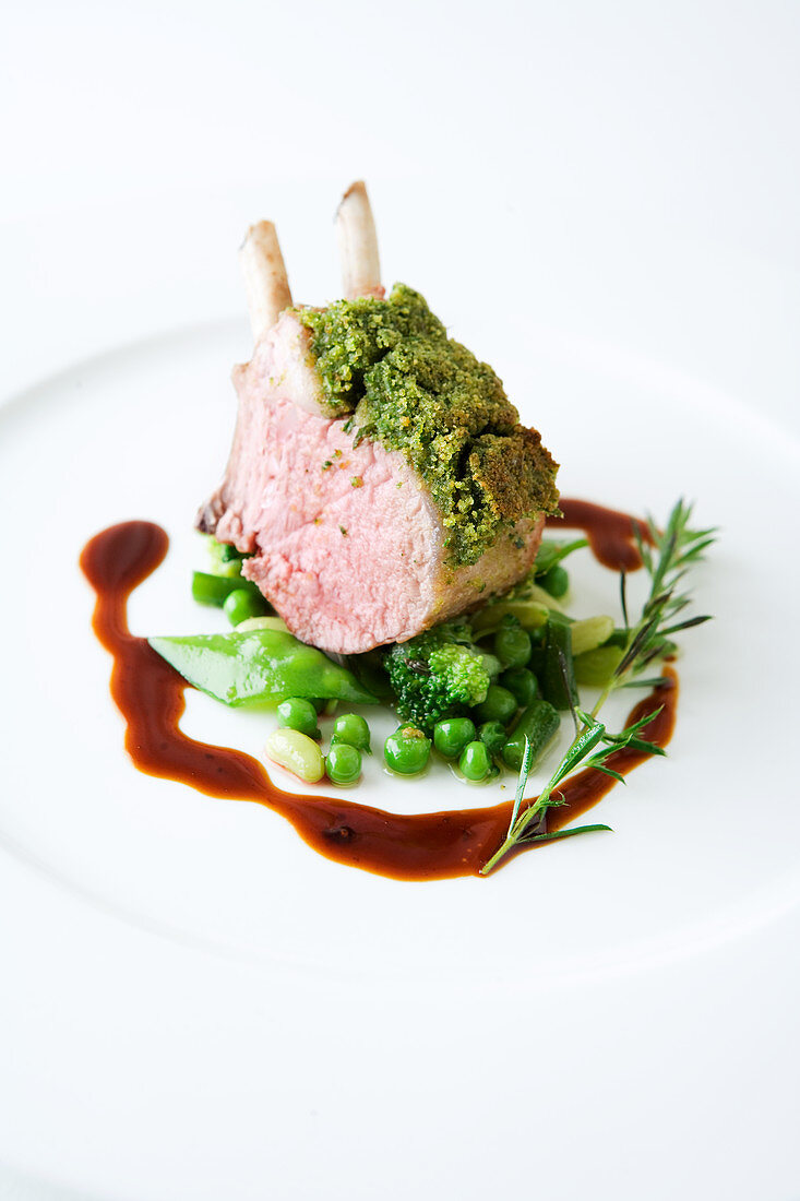 Lamb chop with a bean crust on green vegetables