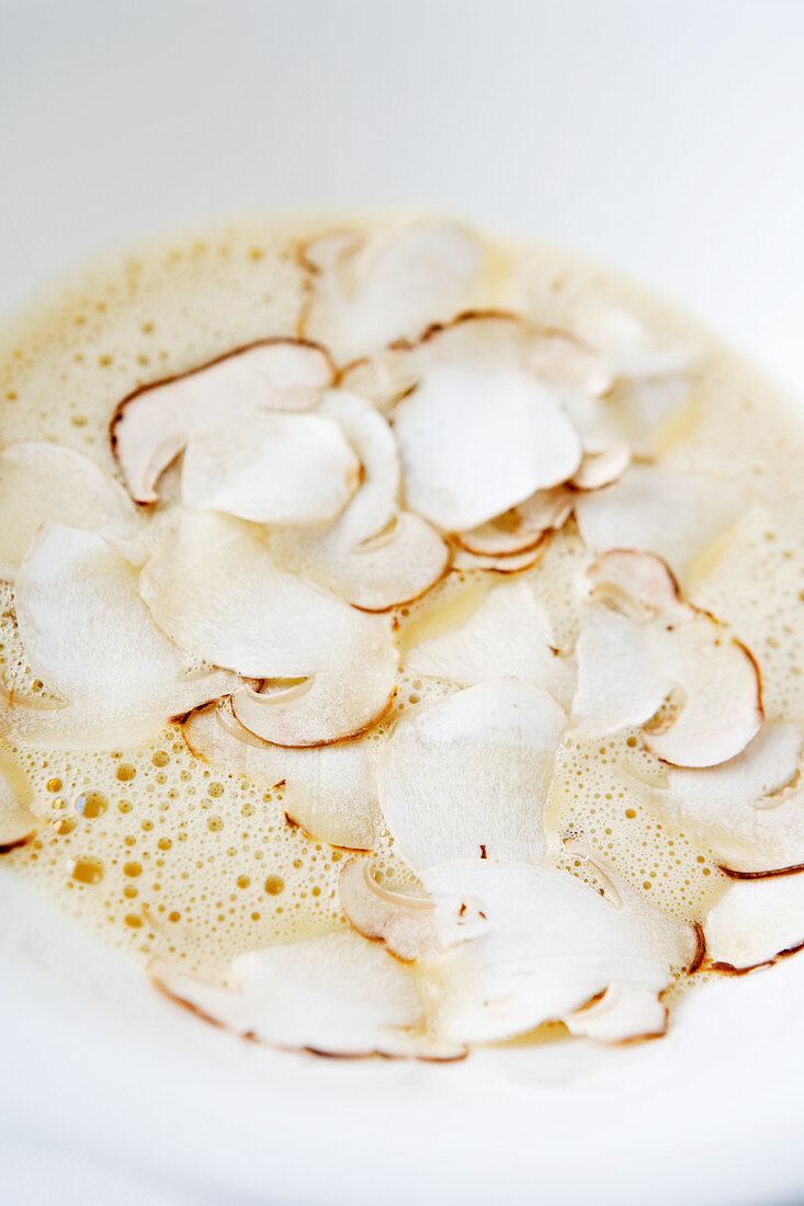 Artichoke soup with sliced porcini mushrooms