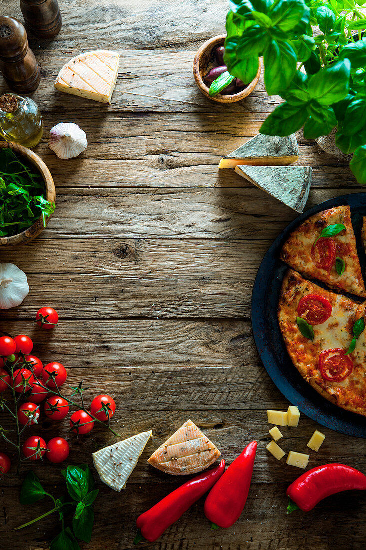 Italian pizza ingredients with cheese, tomatoes and basil