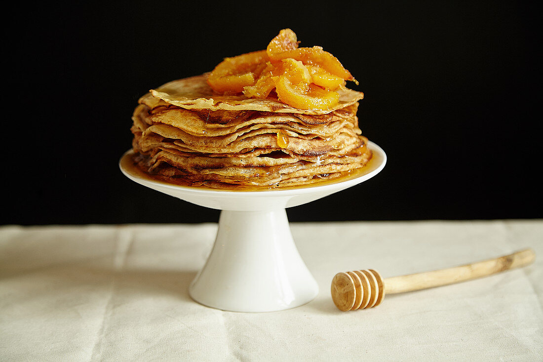 Crepes cake with orange jam and honey