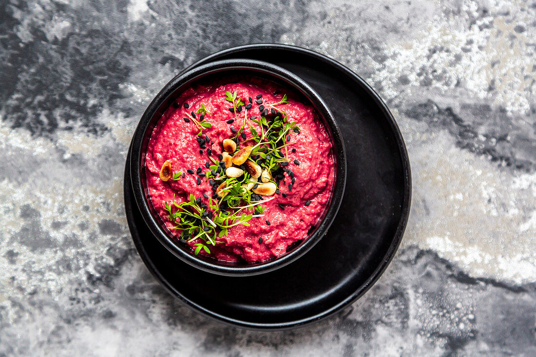 Beetroot hummus with roasted pine nuts and cress