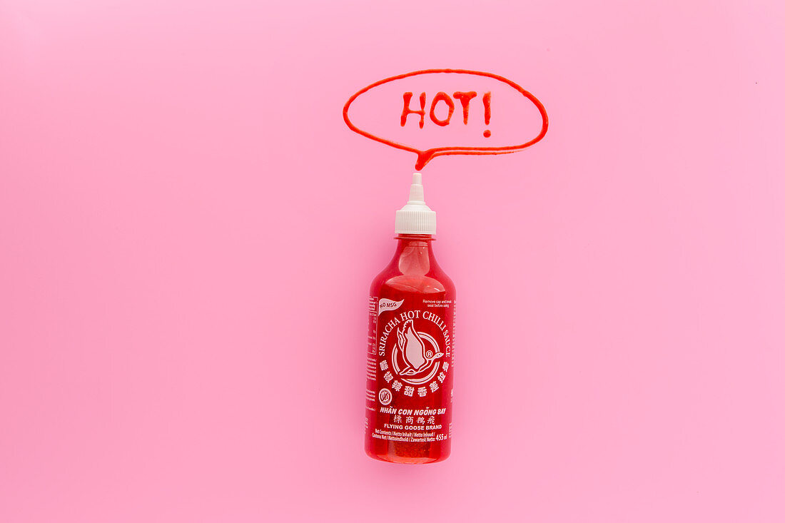 A bottle of sriracha sauce with the word 'Hot!' in a speech bubble