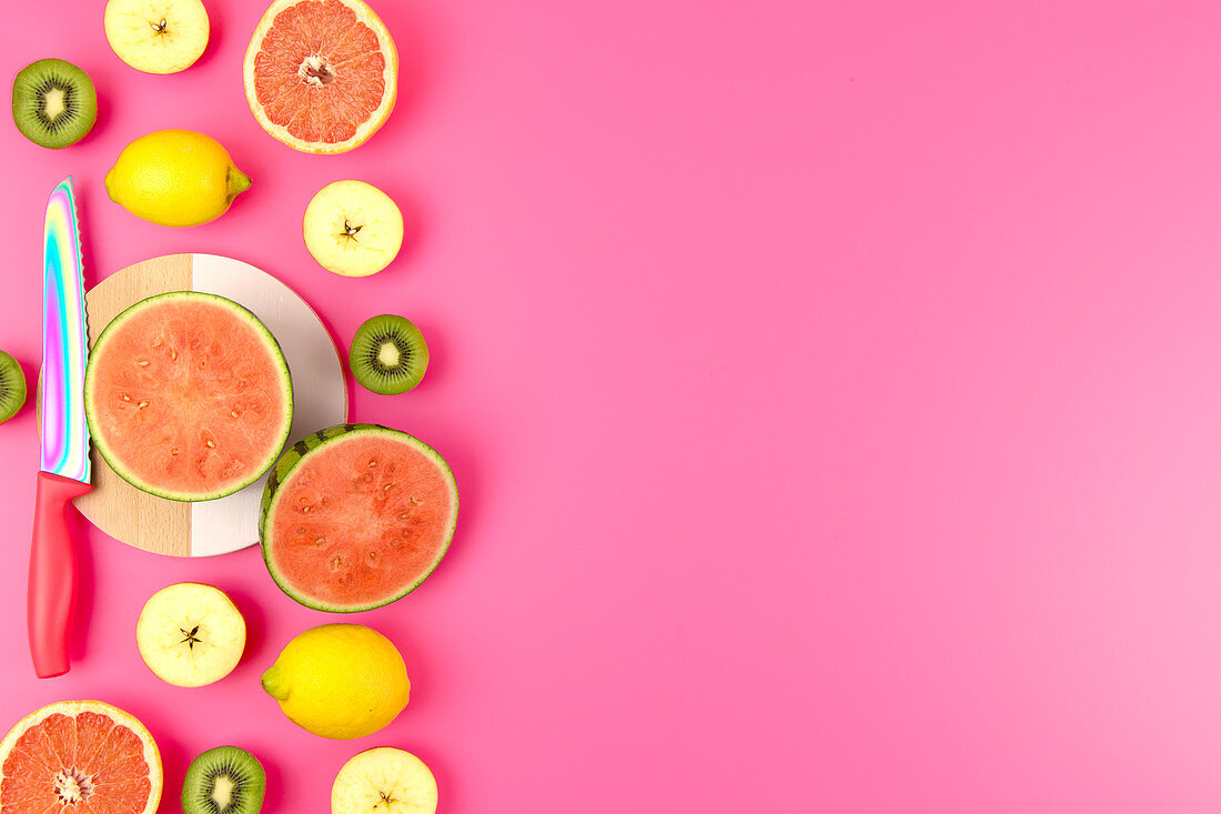 Various fresh fruits with a knife