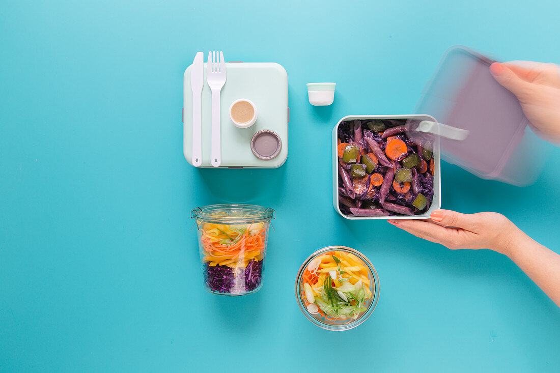 Two different types of take-away oriental food – with pasta and as a salad in a jar