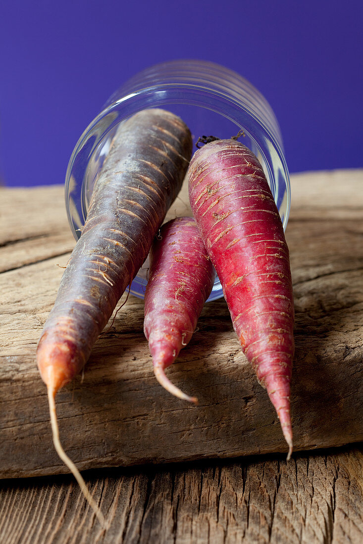 Red and purple carrots in a glass