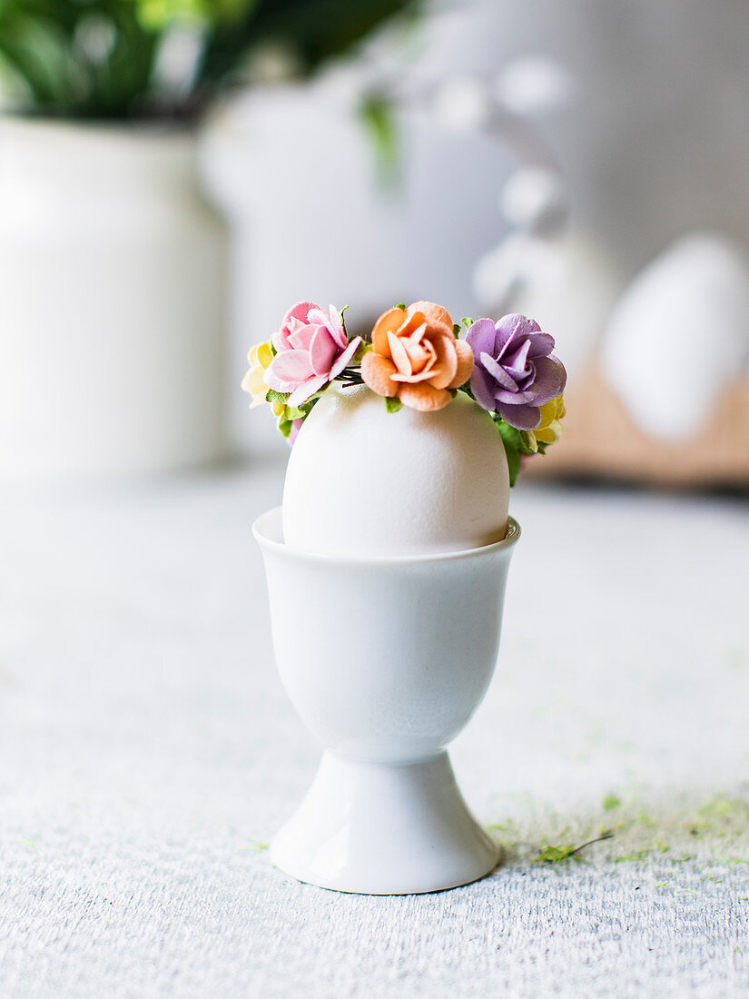 Easter egg with flower decoration in an eggcup