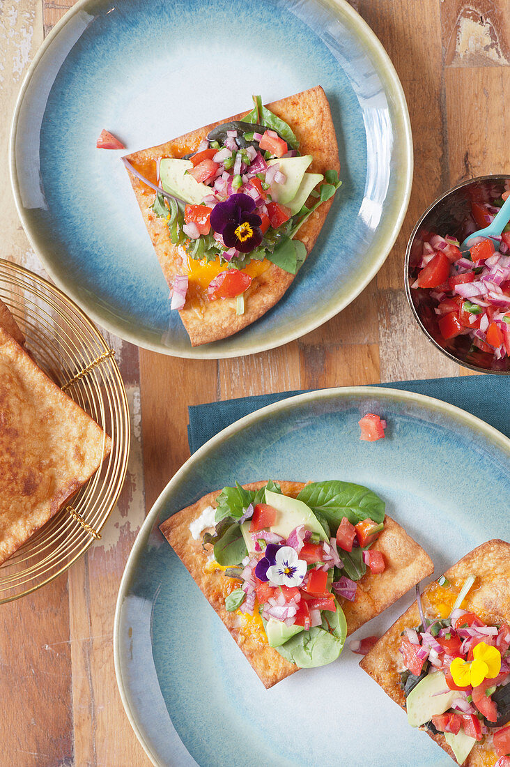 Mini tostadas with tomato and jalapeno salsa, avocado and cheese