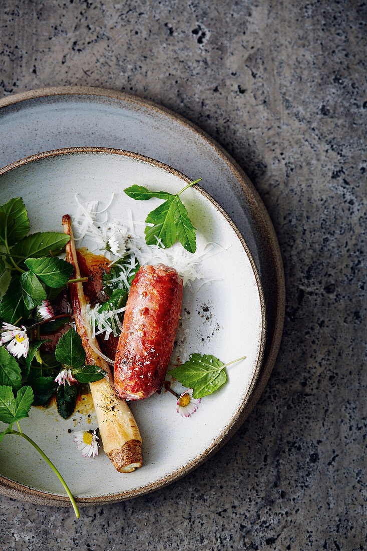 Salsiccia with ground-elder salad, daisies and parsley root