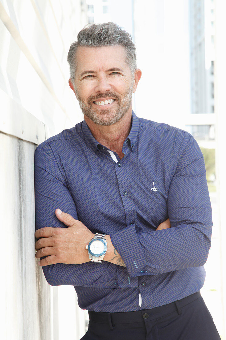 A man with a bread wearing a blue shirt