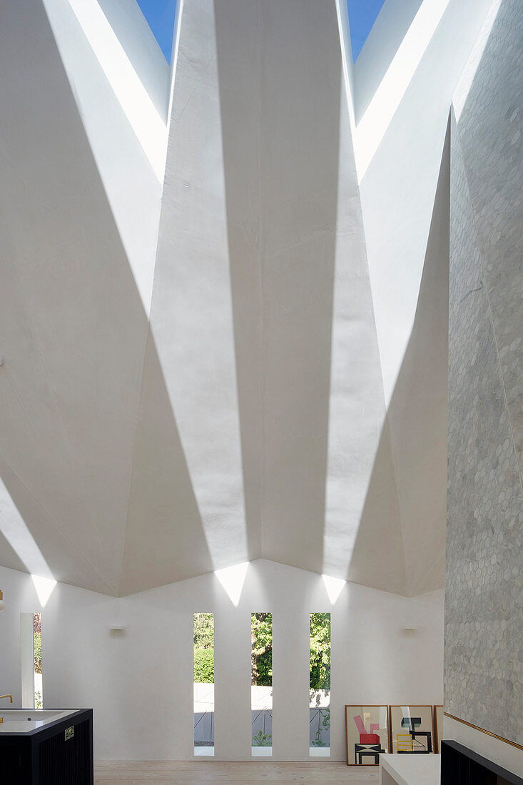 Light falling through faceted ceiling with triangular skylights