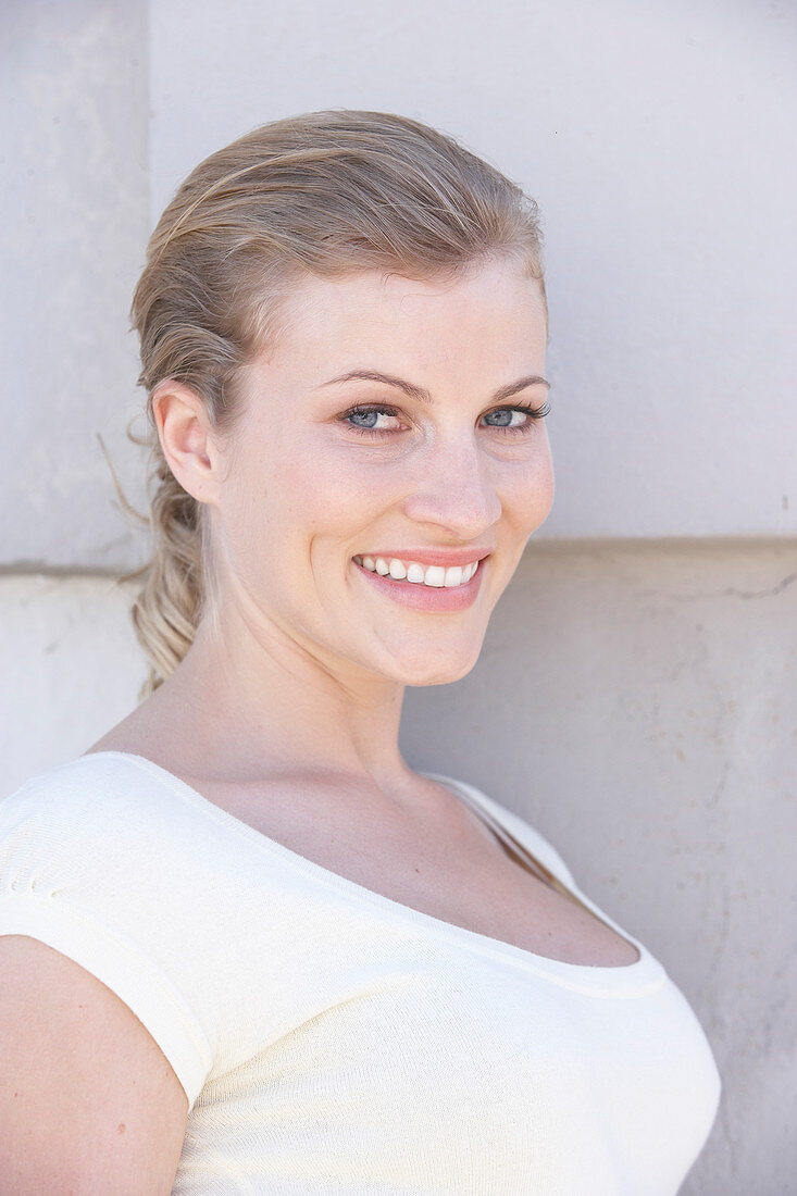 A blonde woman wearing a white shirt