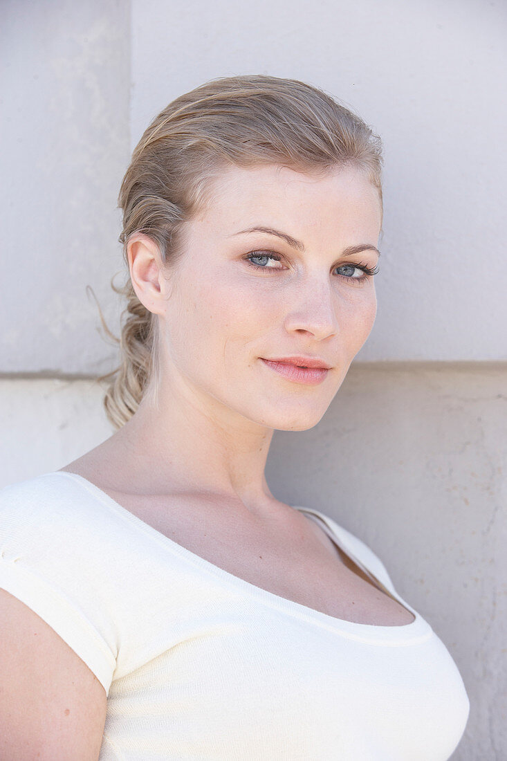 A blonde woman wearing a white shirt