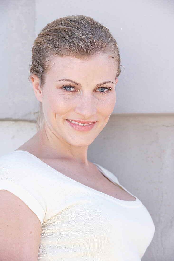 A blonde woman wearing a white shirt