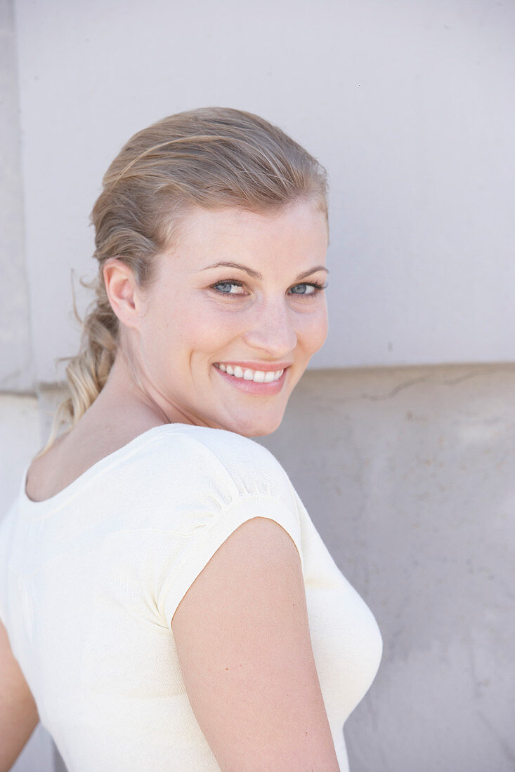 A blonde woman wearing a white shirt