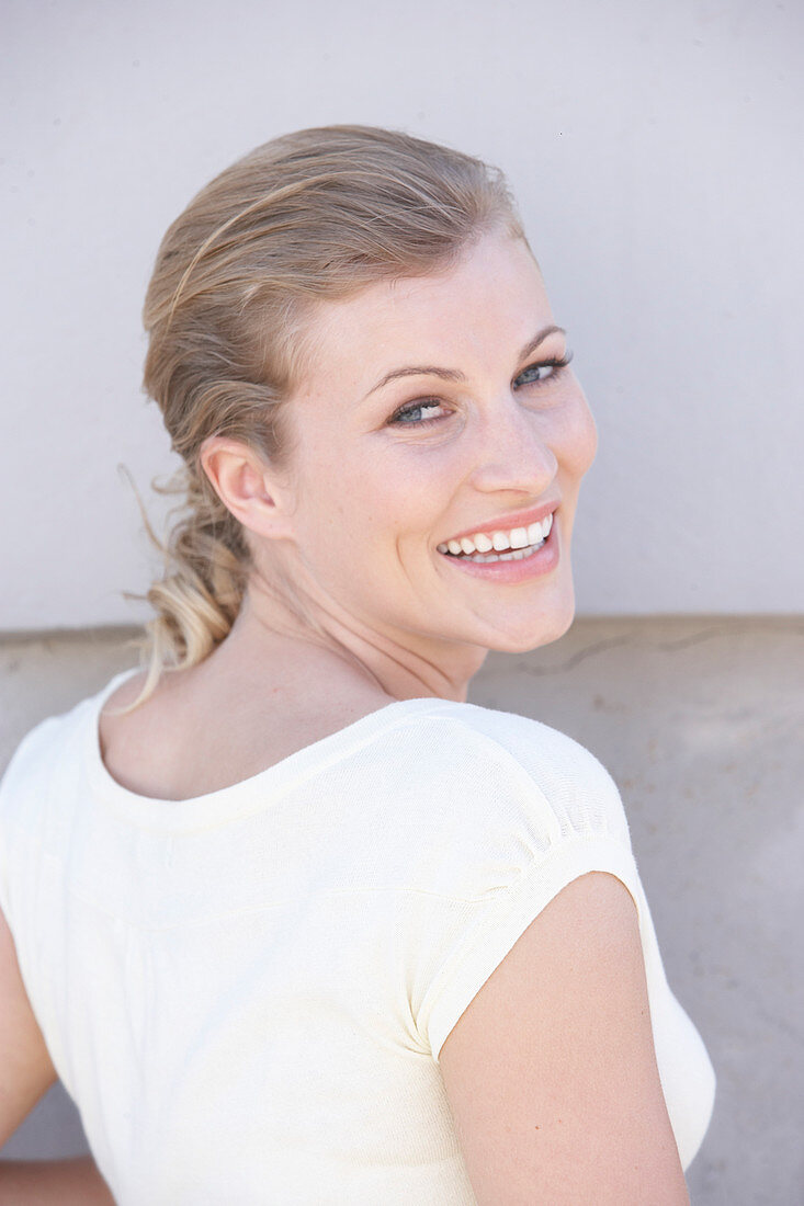 A blonde woman wearing a white shirt