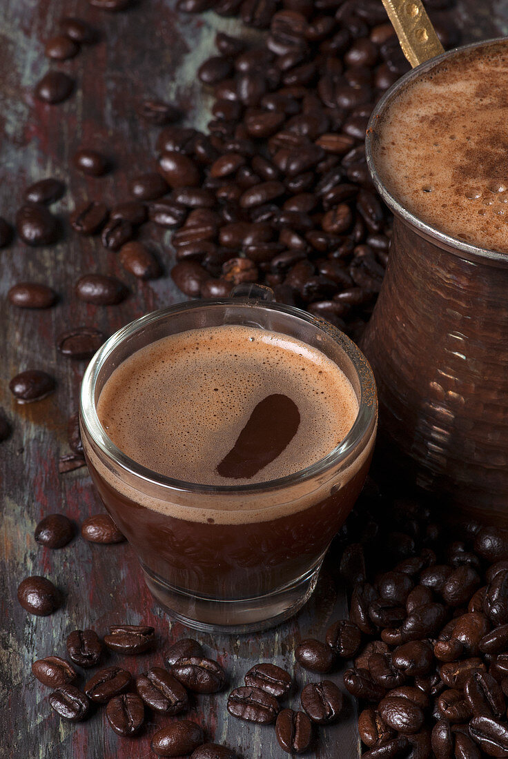 Turkish coffee in a cezve and a glass cup