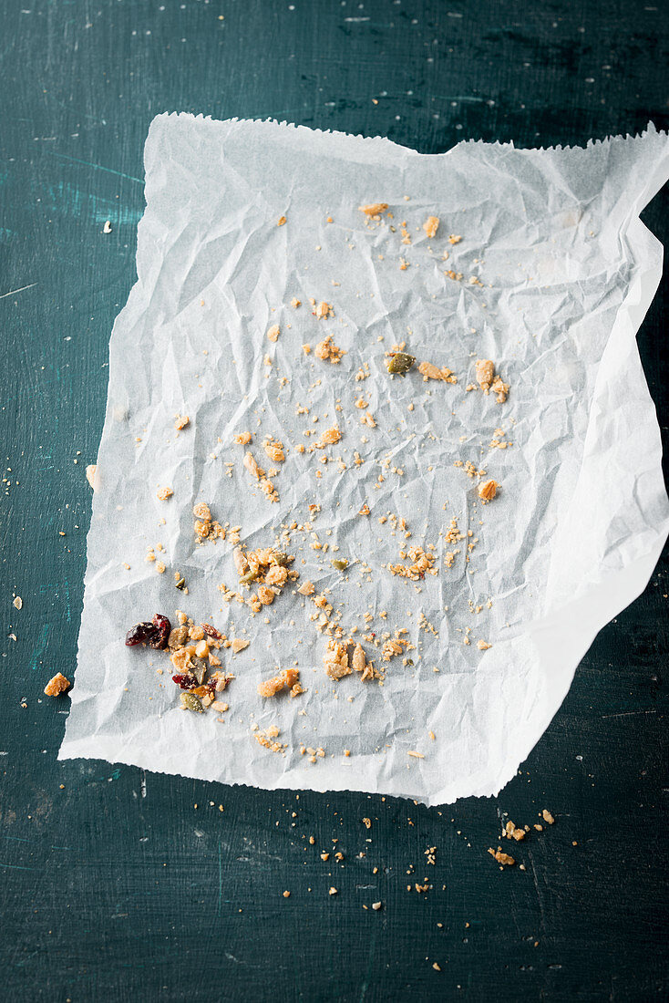 Crumbs of muesli bars on a piece of paper
