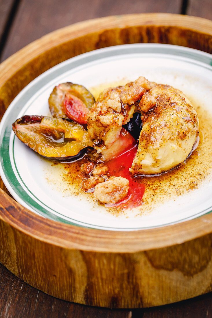 Stuffed quark dumplings with preserved plums and nut crumbs