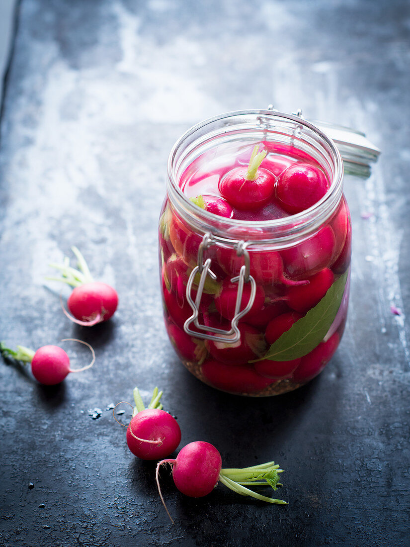 Pickled, fermented radishes in a preserving jar