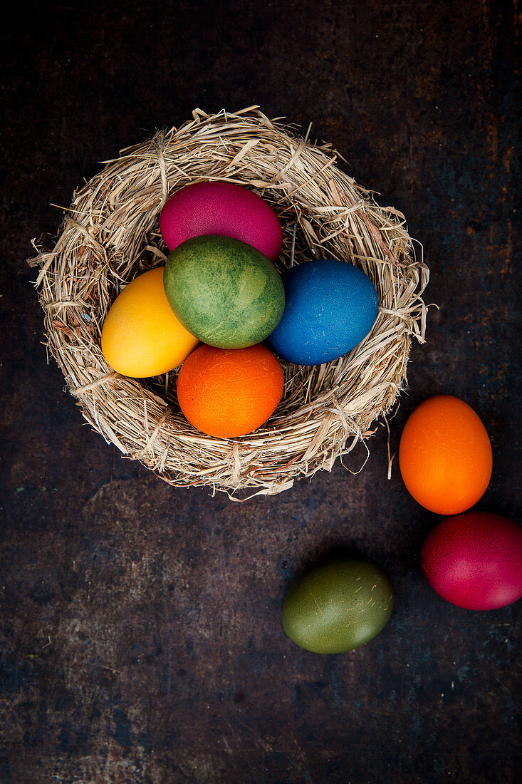 Easter eggs coloured with natural dyes in a nest