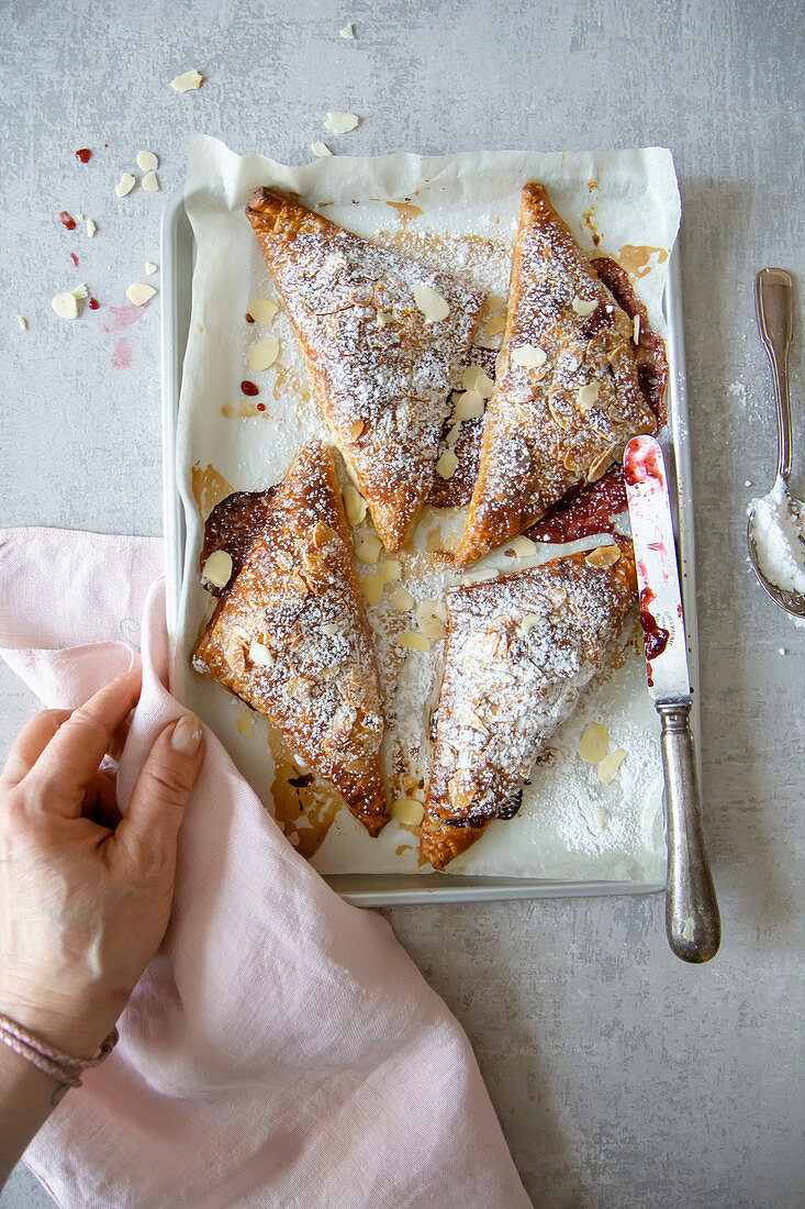 Puff pastries with cherry jam and almonds