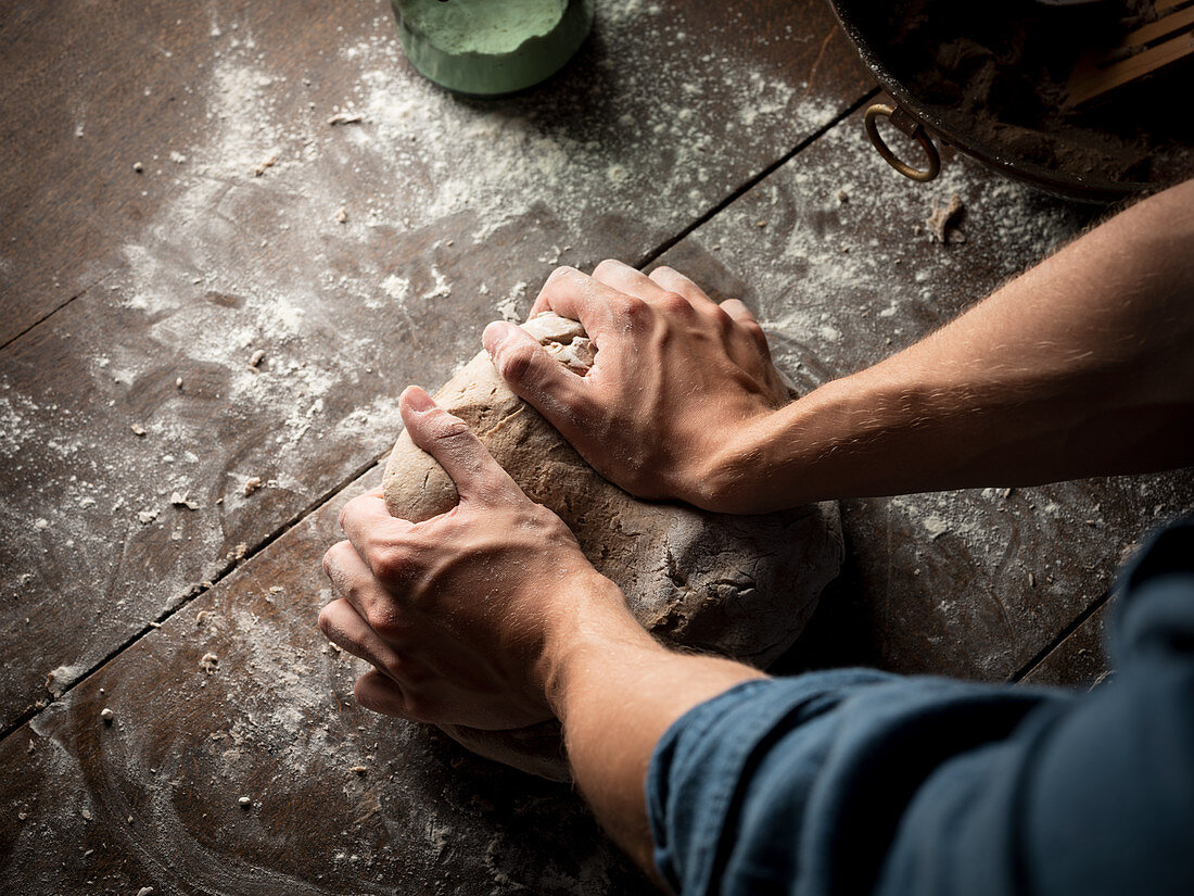 A man kneading bread dough