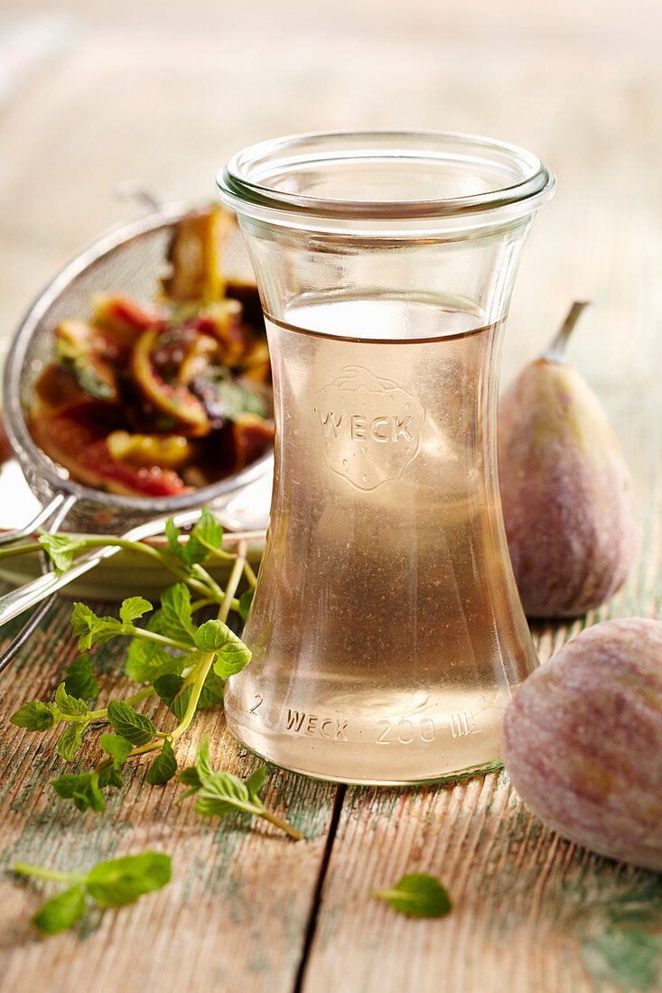 Homemade fig and mint syrup in a preserving jar