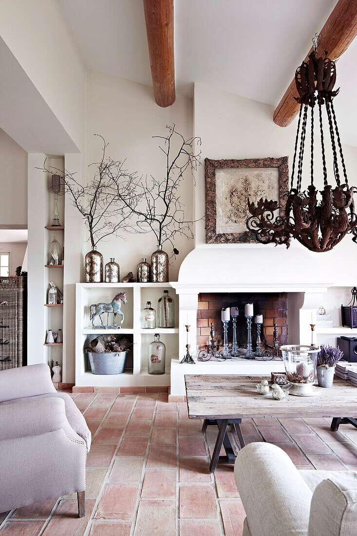 Living room with fireplace and wrought iron chandelier in country house