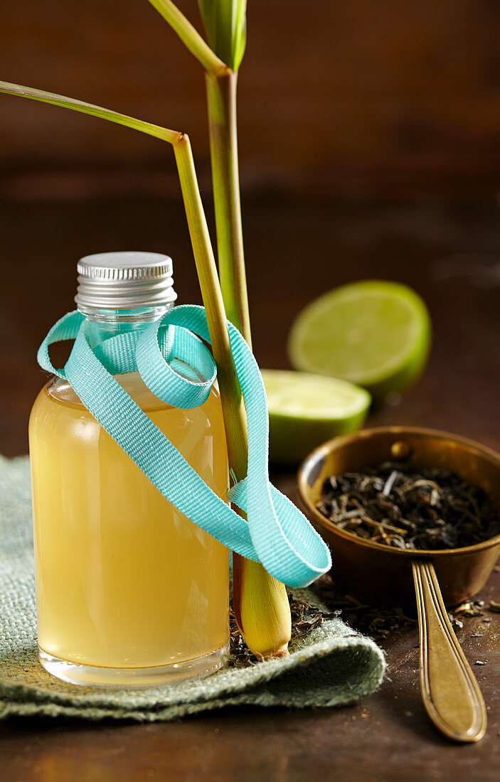 Green tea syrup, limes and lemon grass in a bottle with turquoise ribbon