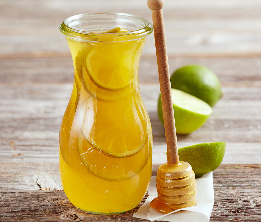 Homemade honey and lime liqueur in a preserving bottle