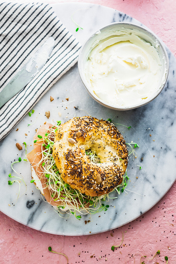 Home made bagel with prosiutto and clover sprouts