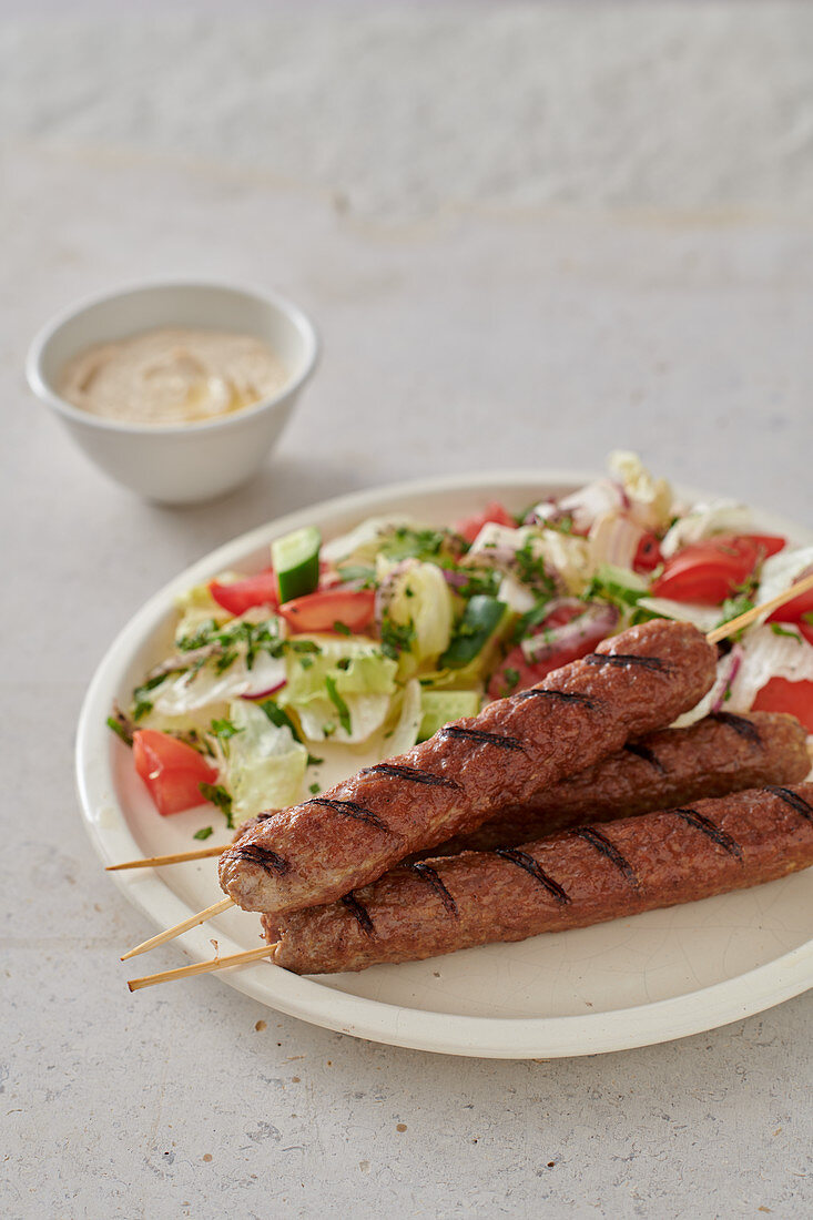 Grilled lamb skewers with salad