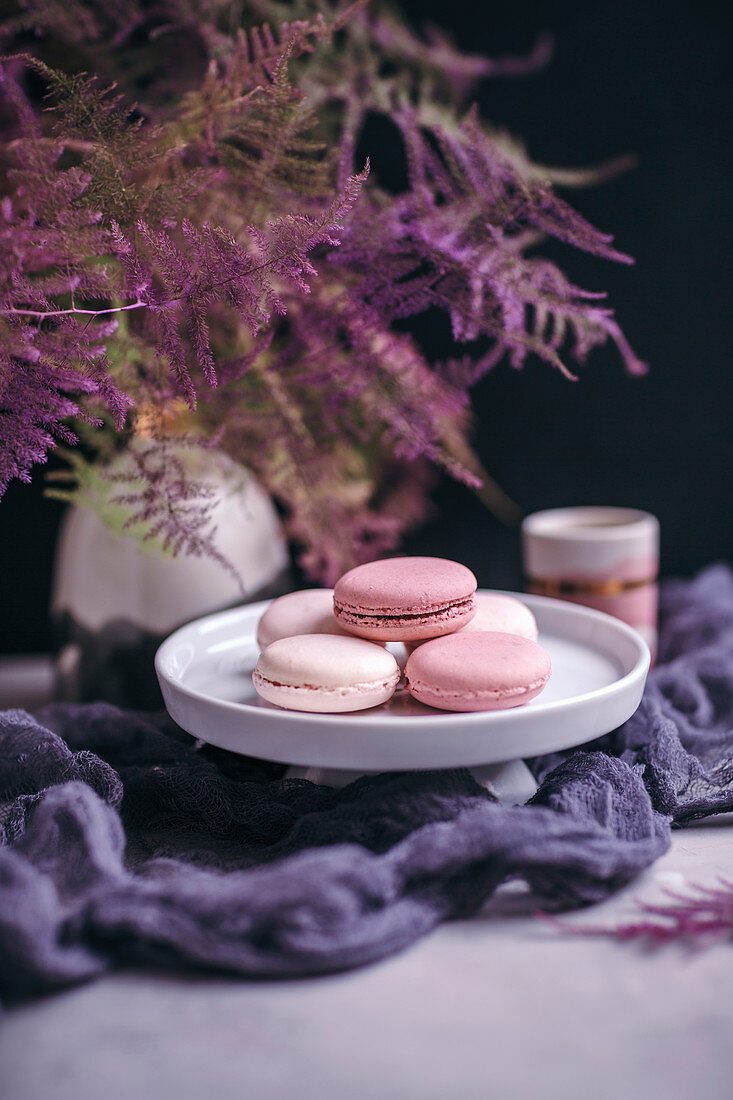 Pink macarons a white cake stand