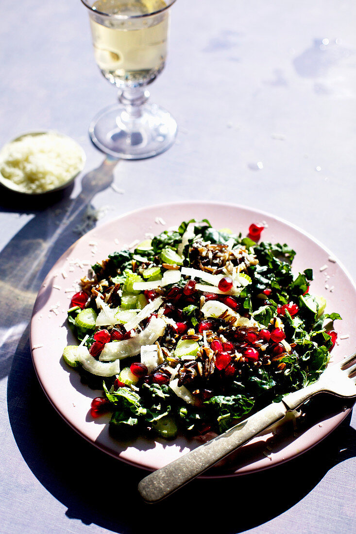 Kale Wild Rice Salad photographed on a violet background