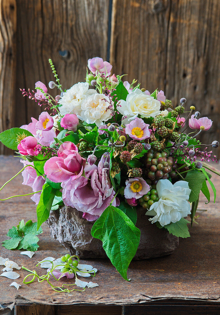 Lavish bouquet of roses, Japanese anemones, blackberries and grapes
