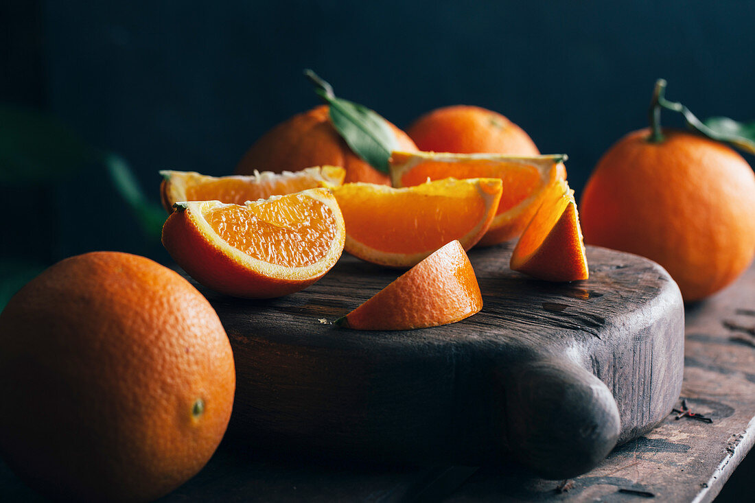 Fresh cut oranges on dark moody background