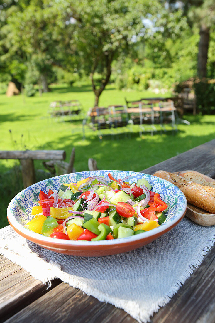 Country salad with cucumbers, tomatoes, peppers and onions