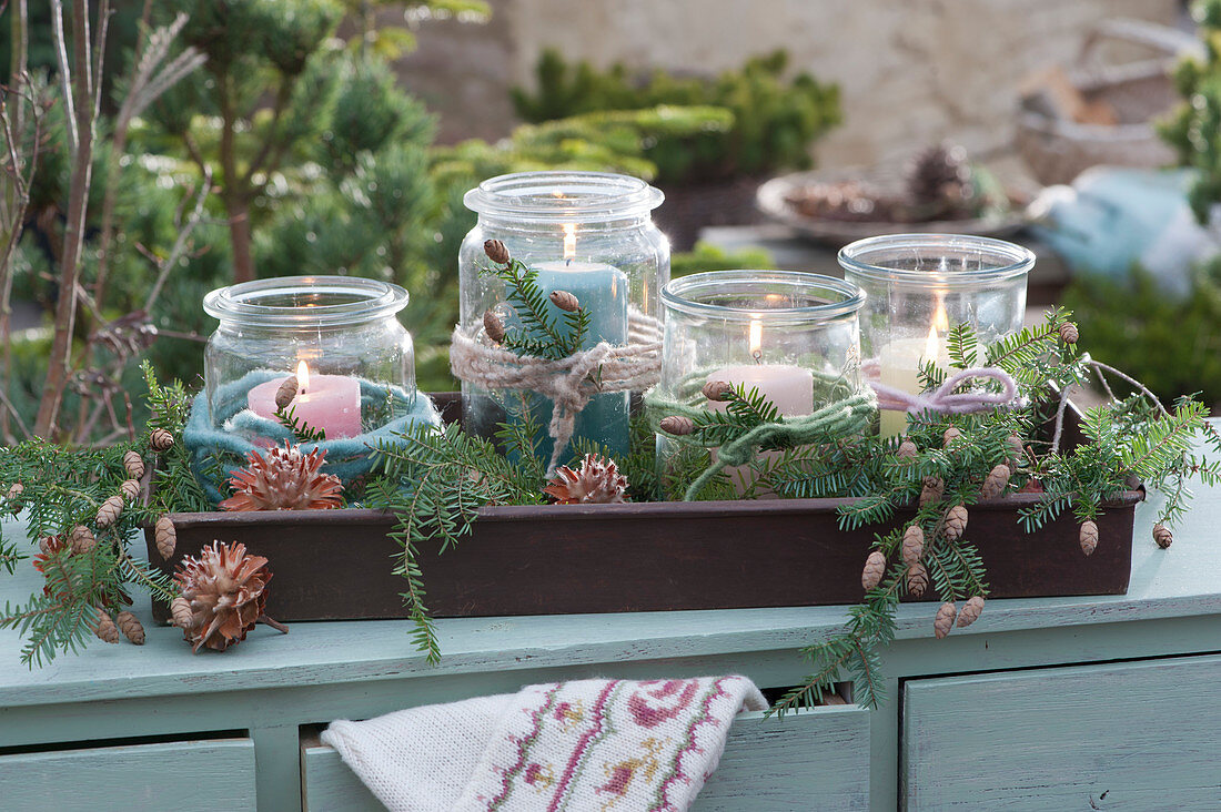 Mason jars with candles and twigs as an advent wreath