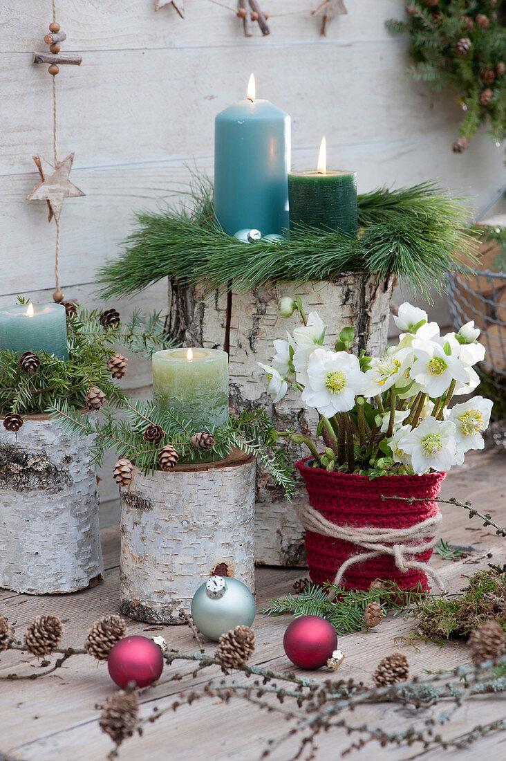 Christmas terrace with Christmas roses, candles, and decorations