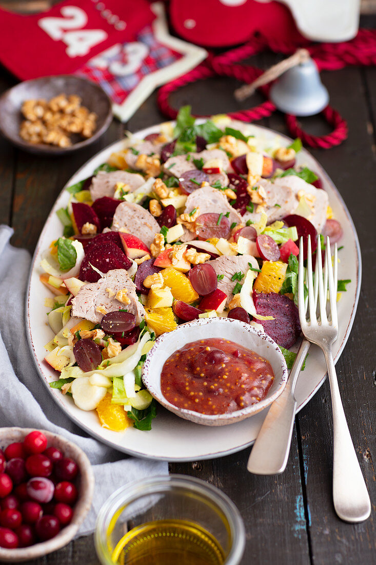 Salad with baked pork, beetroot and fruits
