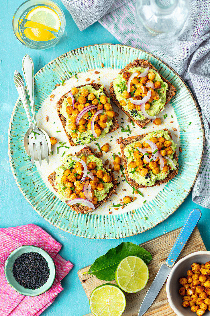 Wholemeal bread with guacamole, baked chickpeas and red onion