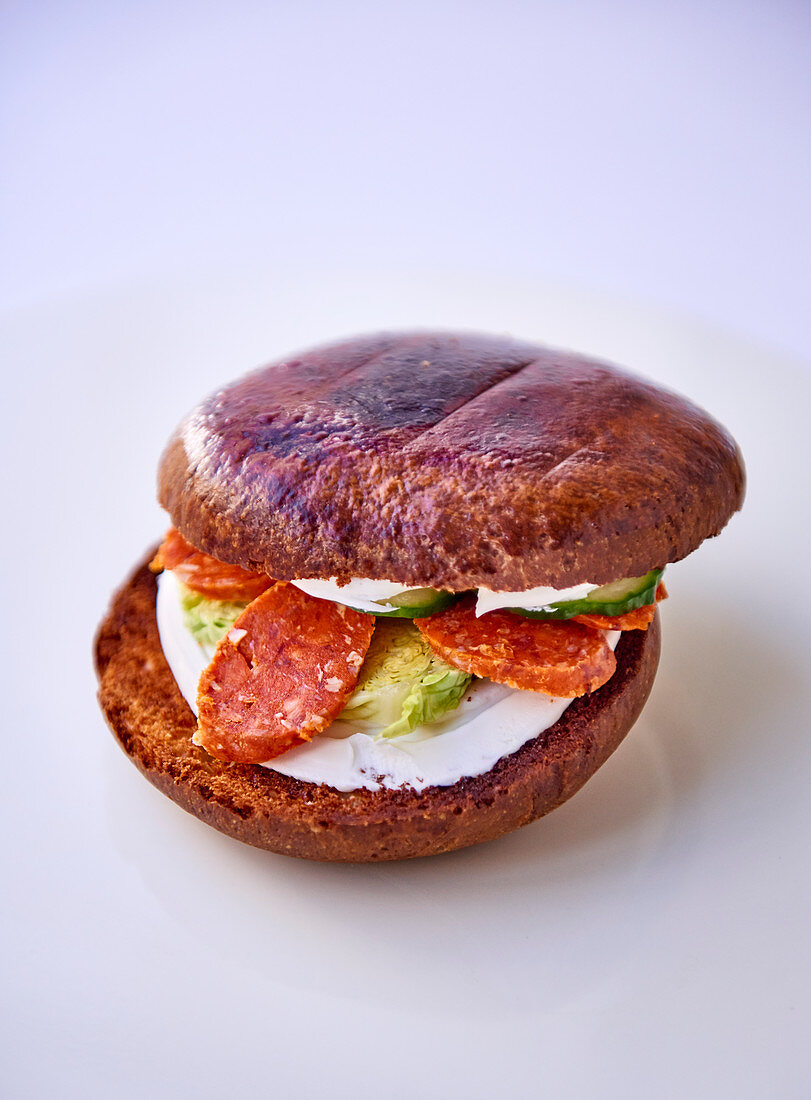 A sandwich with chorizo and cucumber