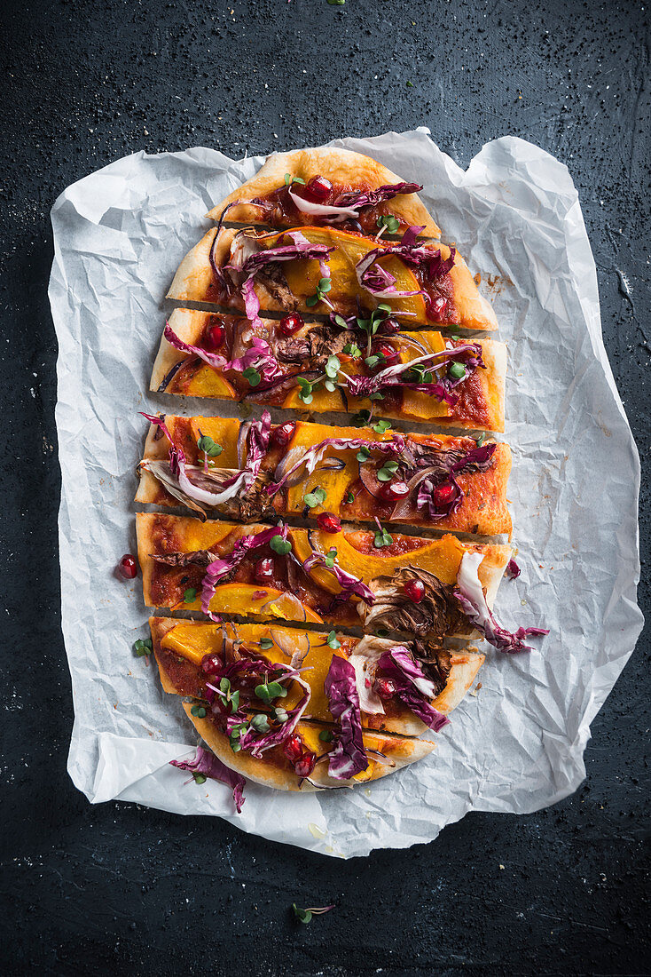 Vegane Dinkelpizza mit Kürbis, Radicchio, roter Zwiebel, Granatapfel und Radieschenkresse
