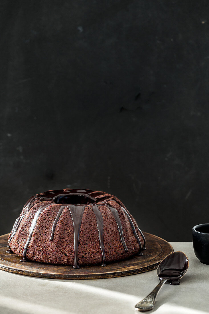 Chocolate donut cake in front of a black background