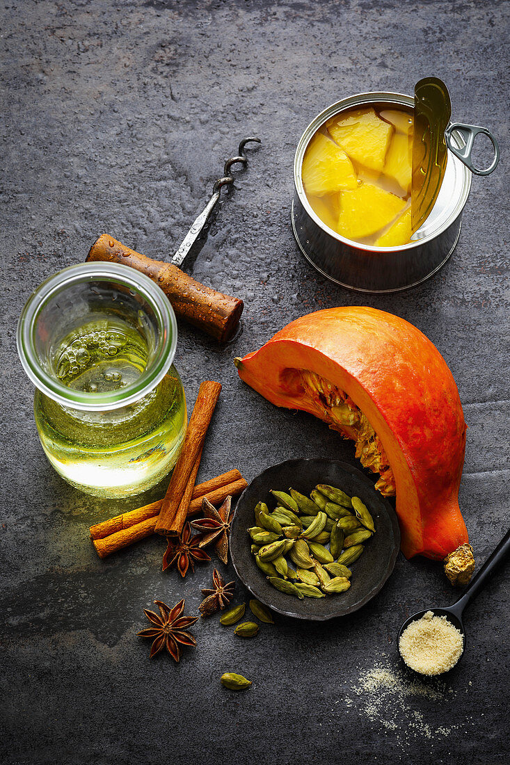 Ingredients for making winter punch with spices, pineapple and pumpkin