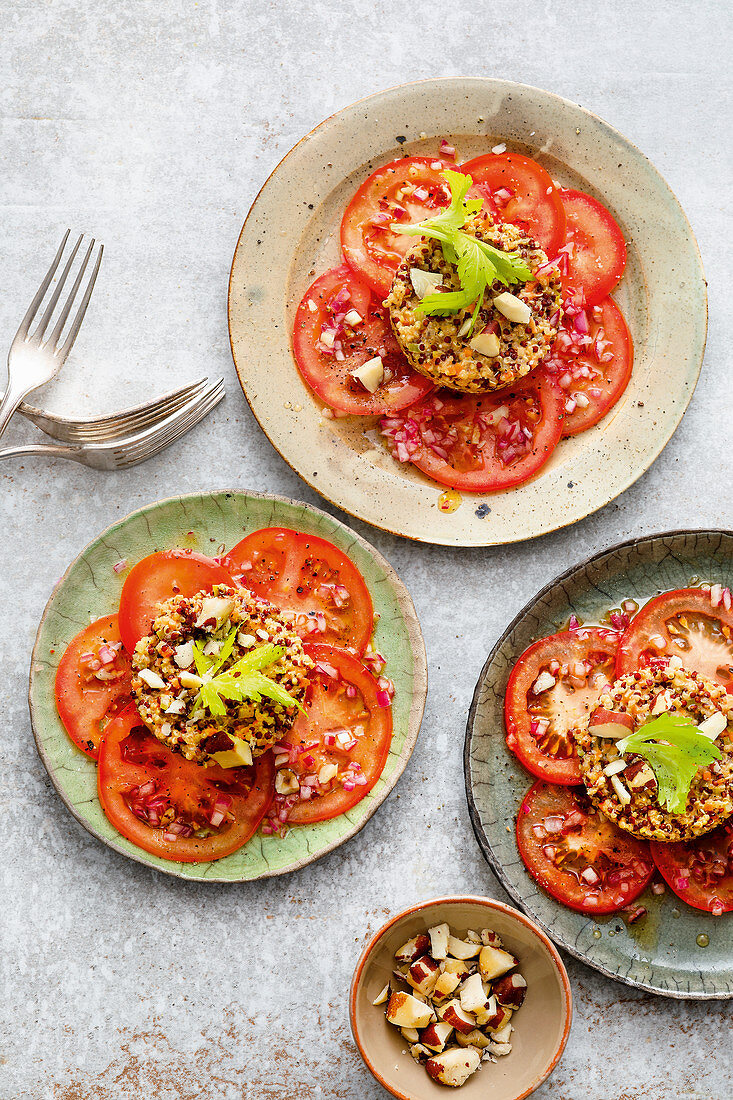 Vegetable tartare with quinoa on tomatoes and brazil nuts