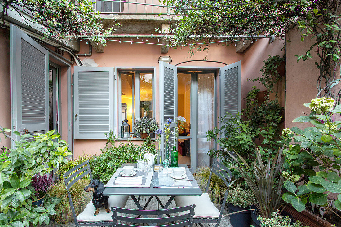 Seating area on Mediterranean terrace behind house