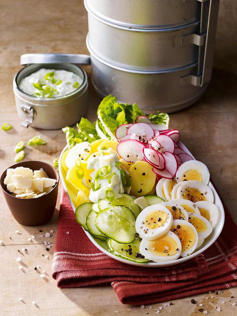 Potato and egg salad with cucumbers and radishes