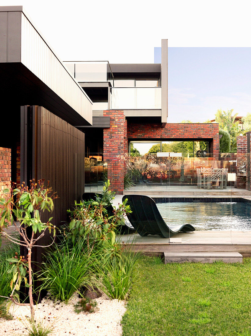 Garden with pool at the modern house with nested facade